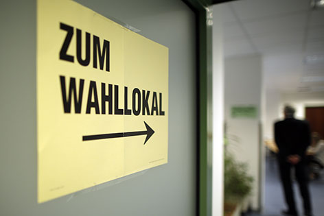 EU-Wahl 2014: Hinweisschild mit der Aufschrift "Zum Wahllokal" aufgenommen  in einem Wahllokal in Wien